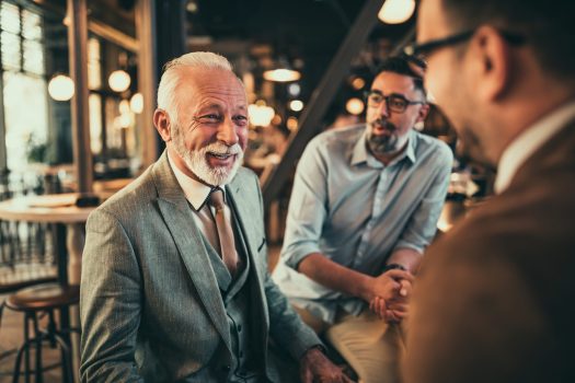 Group of businessmen drinking coffee at cafe